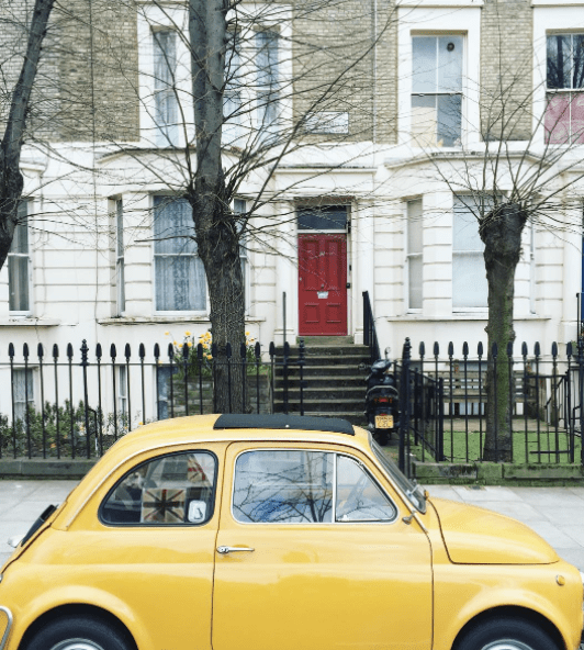 Yellow car and red door in Notting Hill, London
