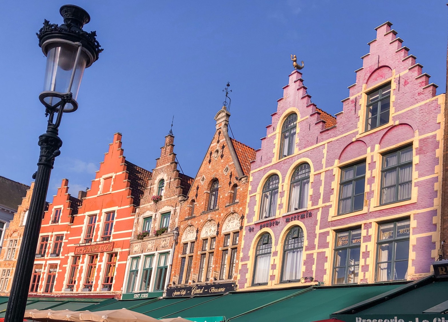 Colourful buildings on the main market square of Bruges. They look like gingerbread houses.